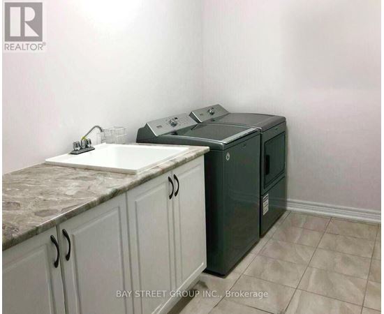 A kitchen with a sink, a dishwasher and cabinets.