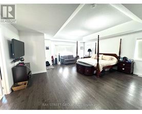 A bedroom with a four poster bed and a television.