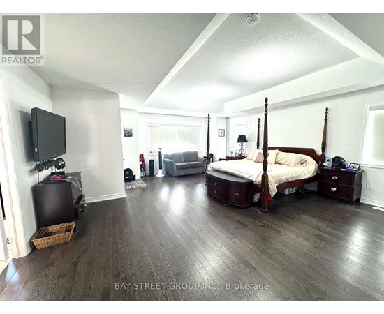 A bedroom with a four poster bed and a television.