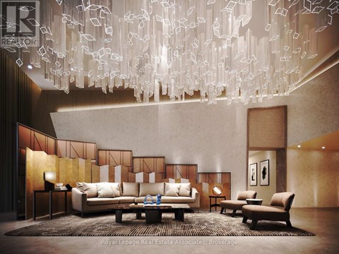 A modern living room with a large chandelier and a sofa set.
