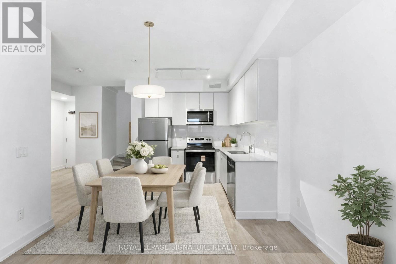 A modern kitchen with a dining table set for four.