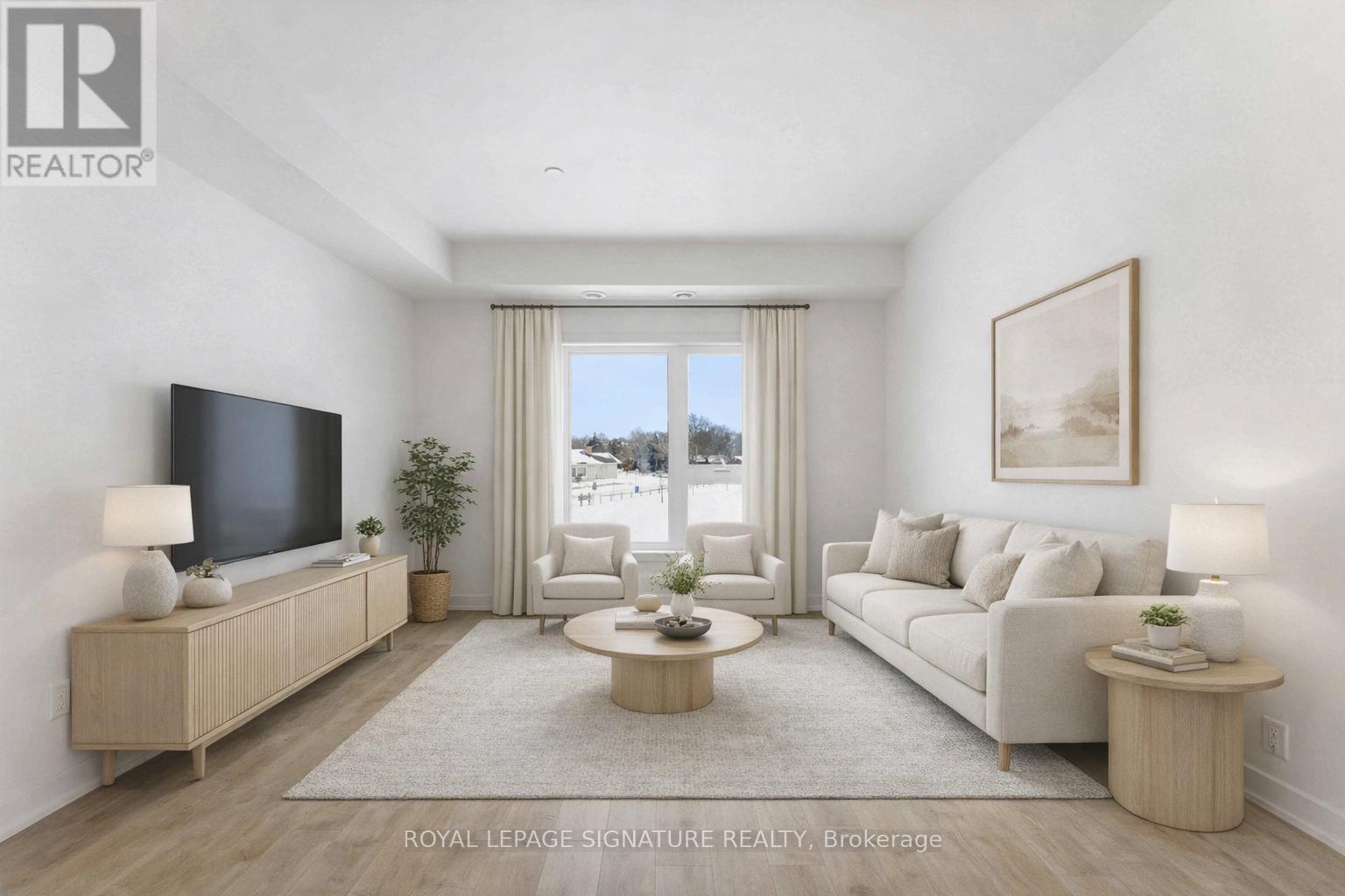 A living room with a flat screen TV, a sofa, a coffee table, and a large window with a view of the city.