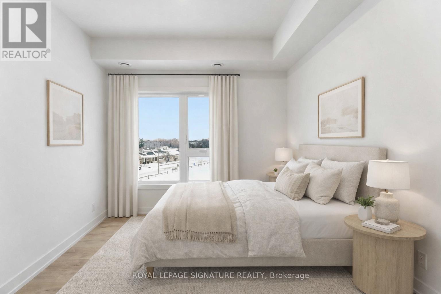 A bedroom with a large bed and a view of a snowy landscape outside the window.