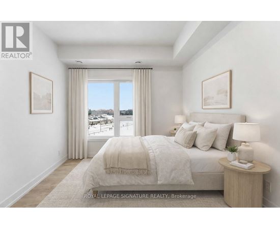 A bedroom with a large bed and a view of a snowy landscape outside the window.