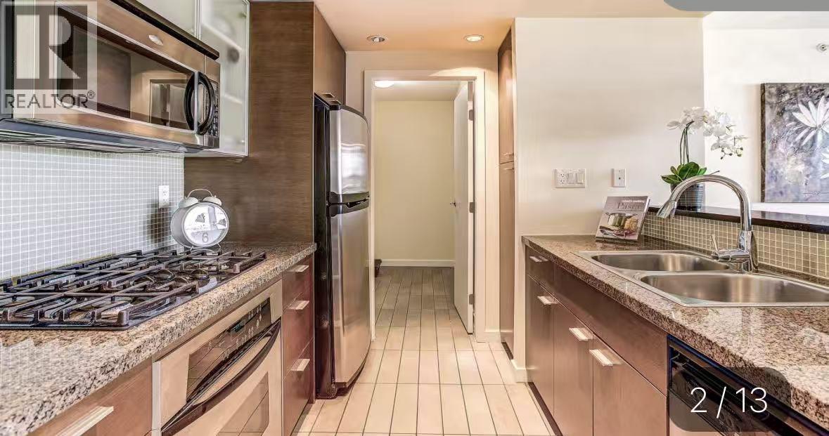 A kitchen with granite countertops and stainless steel appliances.