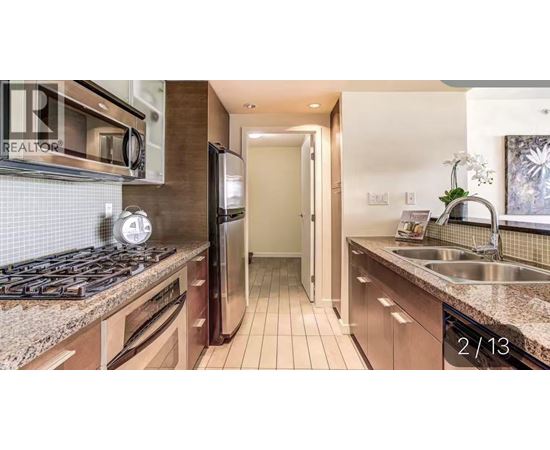 A kitchen with granite countertops and stainless steel appliances.