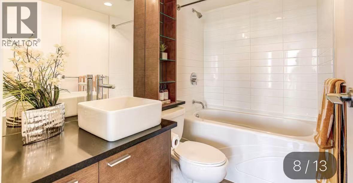 A modern bathroom with a white toilet and a bathtub.