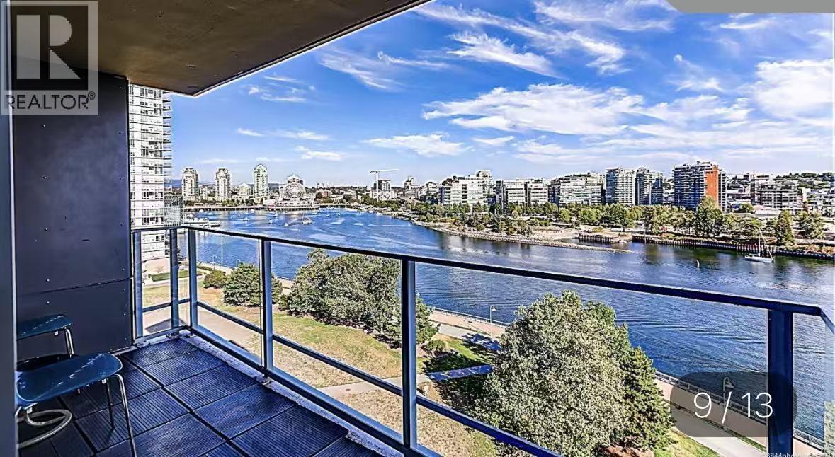 A balcony with a view of a river and buildings.