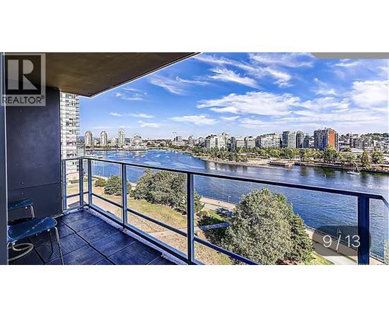 A balcony with a view of a river and buildings.