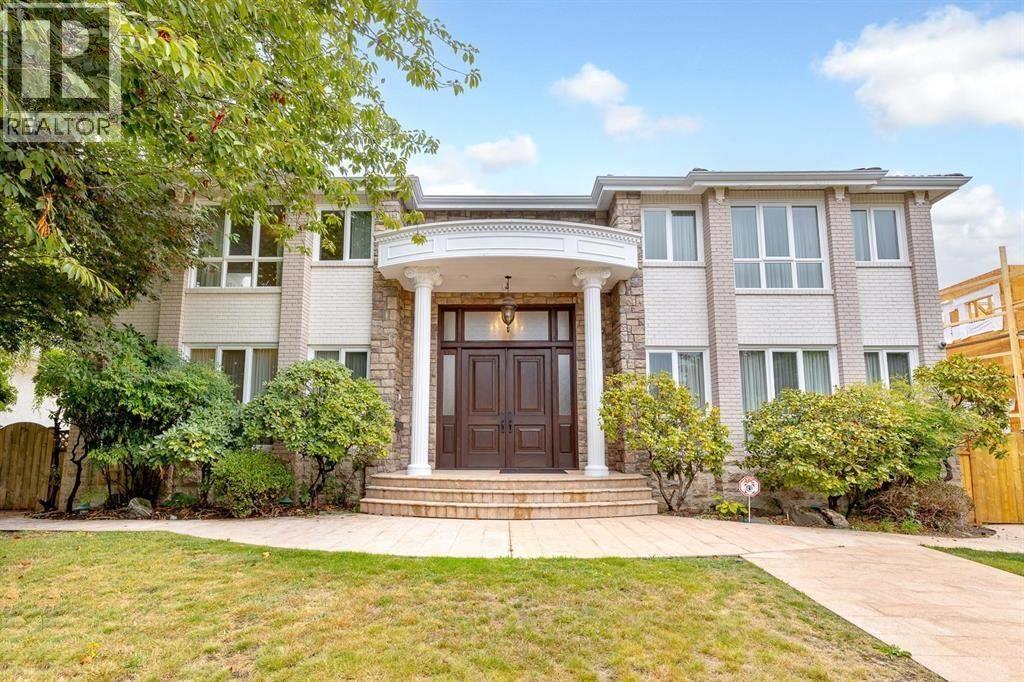 A house with a brown front door and a small front yard.