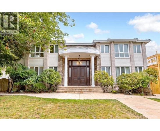 A house with a brown front door and a small front yard.