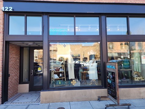 A storefront with a glass window display and a sign that reads "NOOKA".