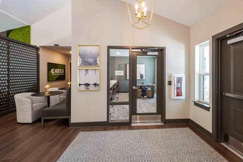 A modern living room with a grey sofa and a glass door.