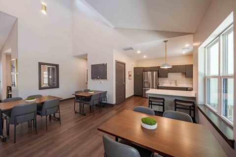 A modern kitchen with a dining table and chairs.