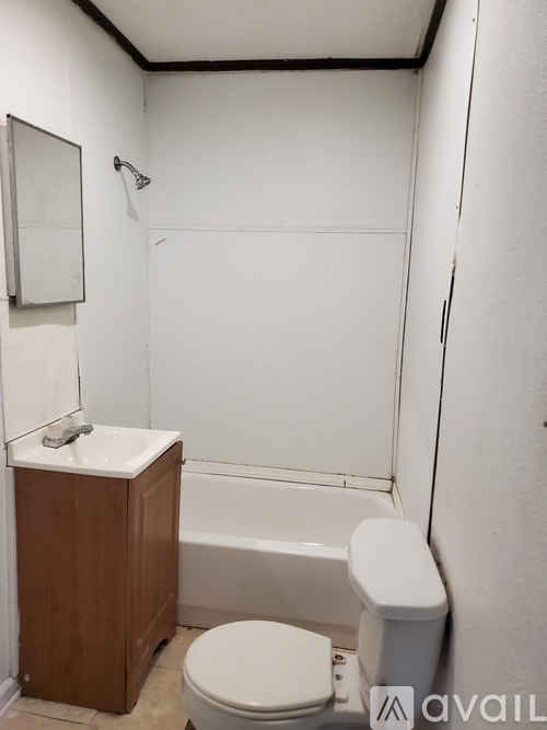 A small bathroom with a toilet, sink, and bathtub.