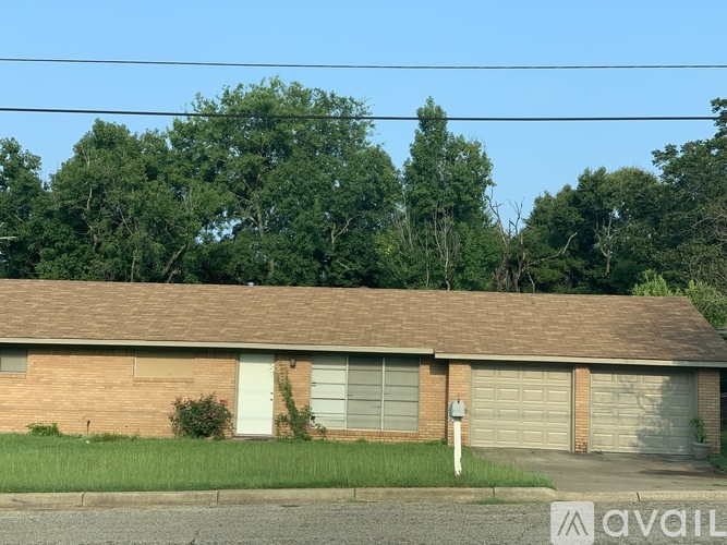 A house with a garage door is for sale.
