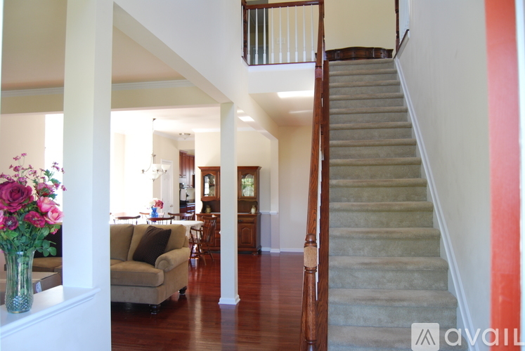 A living room with a couch and a staircase.