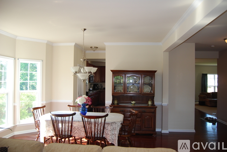 A dining room with a table set for four.