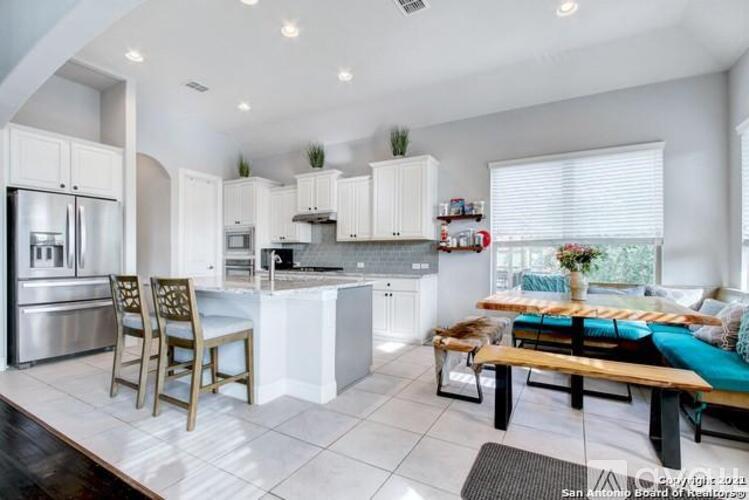 A modern kitchen with a dining table and chairs.