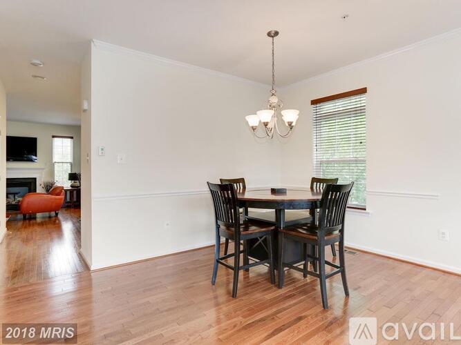 A dining room with a wooden table and chairs.
