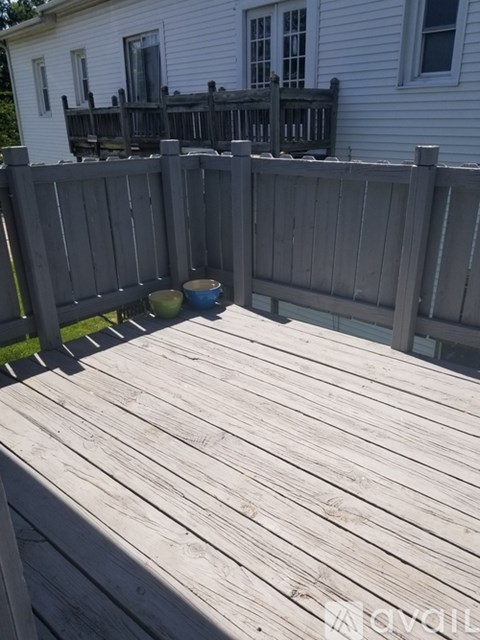 A wooden deck with a bowl on it.