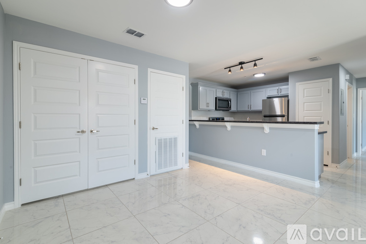 A kitchen with white cabinets and a countertop.