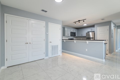 A kitchen with white cabinets and a countertop.