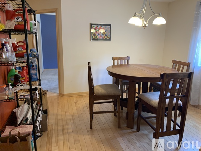 A dining room with a wooden table and chairs.