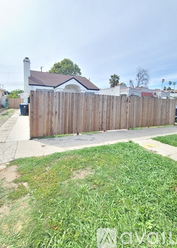A wooden fence in front of a house.