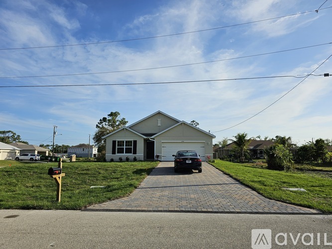 A house with a driveway and a car parked in front.