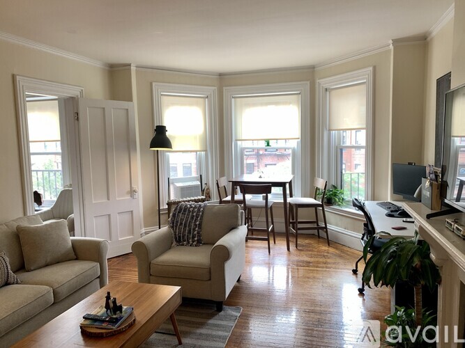A living room with a couch, chair, and coffee table.