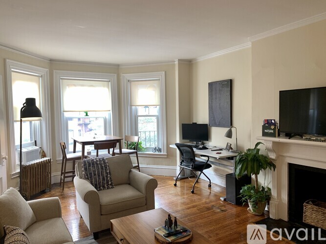 A living room with a fireplace and a television.