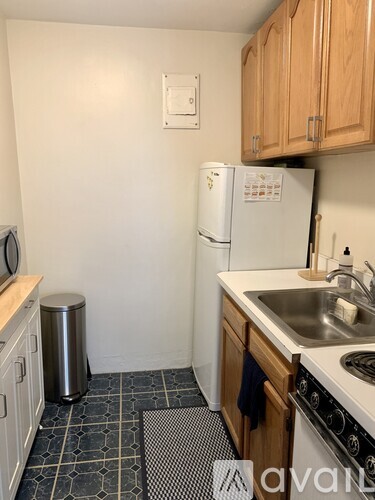 A kitchen with a white fridge and a white microwave.