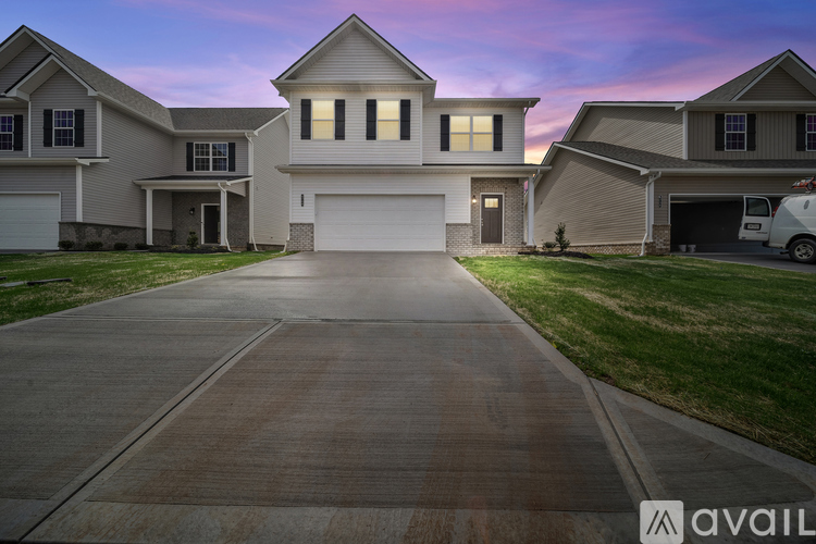 A large house with a driveway in front of it.