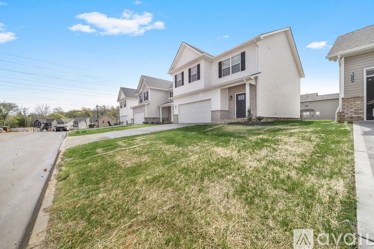 A row of houses with a grassy front yard.