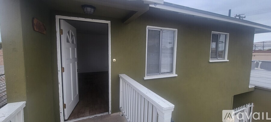 A house with a green wall and a white door.