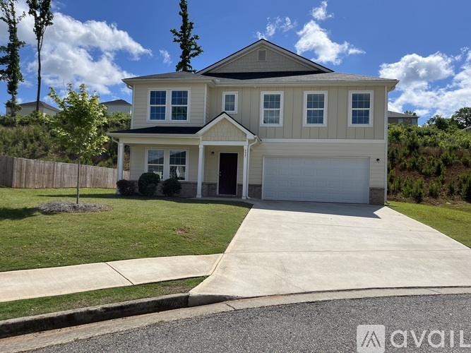 A two-story house with a garage is for sale.