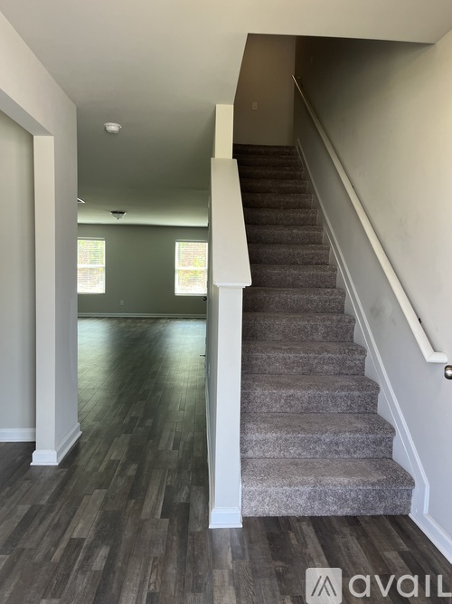 A staircase with a carpeted runner and white risers.