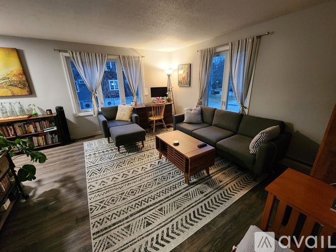 A living room with a patterned rug and a couch.