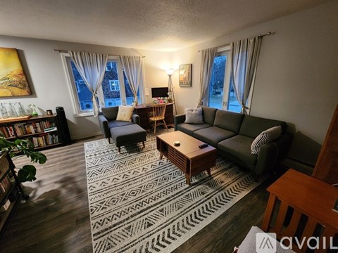 A living room with a patterned rug and a couch.
