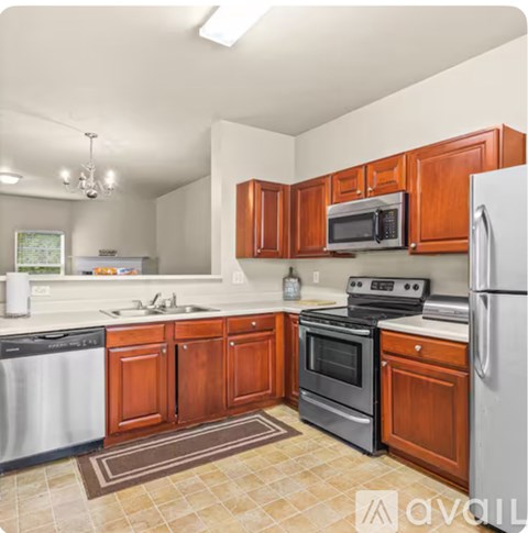 A kitchen with wooden cabinets and a white refrigerator.
