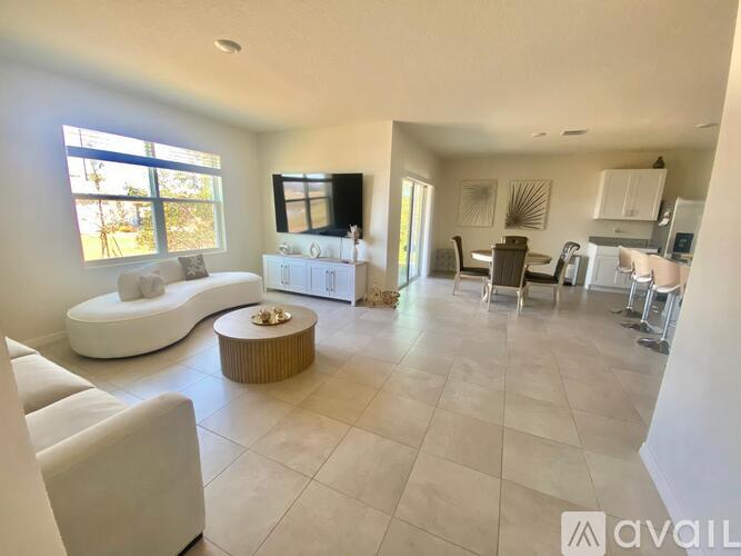 A modern living room with a white sofa and a coffee table.