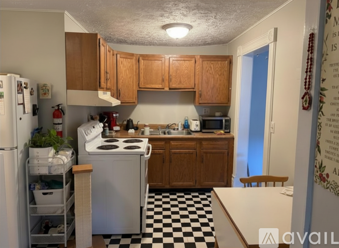 A kitchen with a black and white checkered floor.