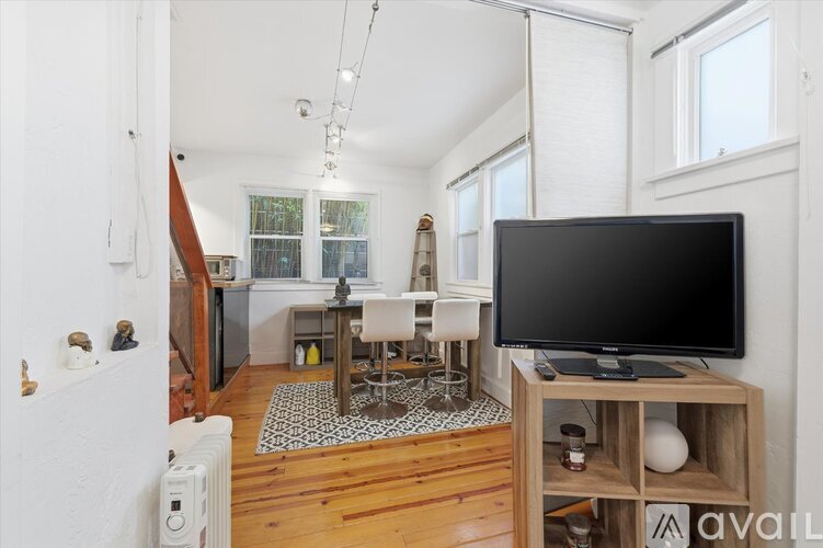 A living room with a television on a wooden stand.