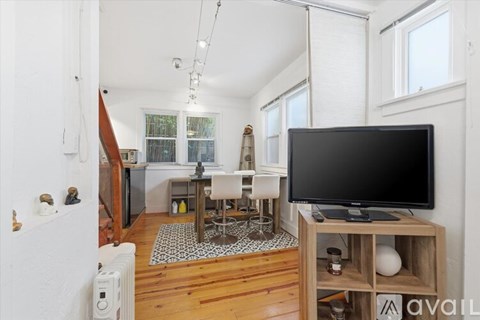 A living room with a television on a wooden stand.
