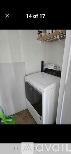 A white microwave oven is placed in a small kitchen.