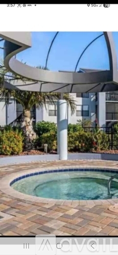 A modern outdoor pool area with a curved metal structure.