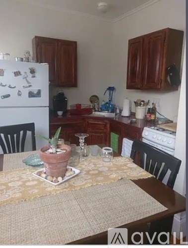 A kitchen with a table set for a meal.