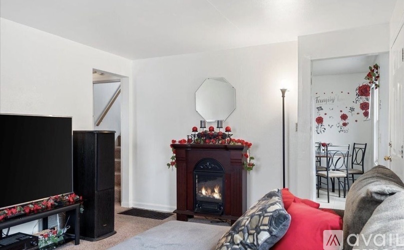 A living room with a fireplace, a television, and a couch.