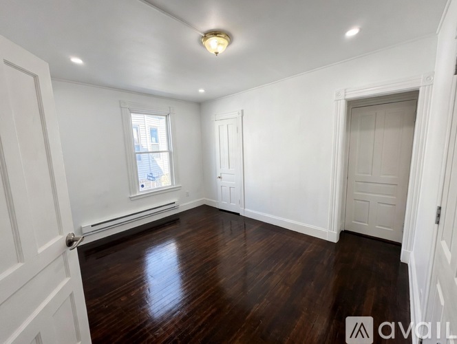 A room with wooden floors and white walls.